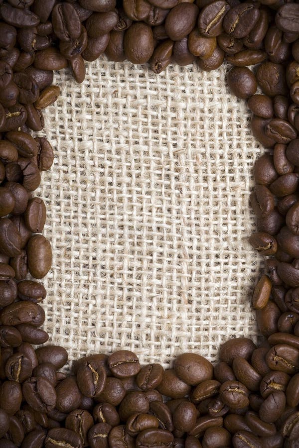 A frame of coffee beans on burlap sack texture. A frame of coffee beans on burlap sack texture