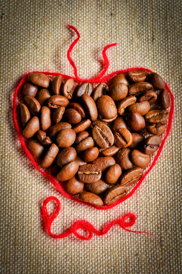 Heart made of coffee beans and red line. To stand out. Vignette added. Heart made of coffee beans and red line. To stand out. Vignette added