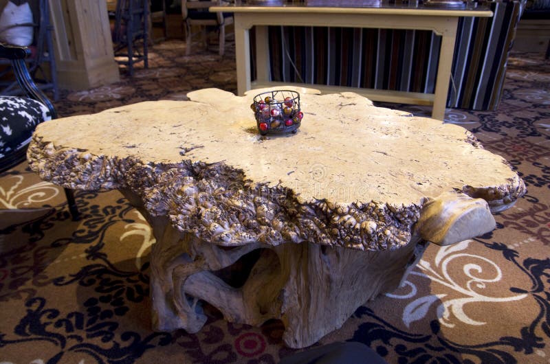 Beautiful artwork of coffee or tea table made of a big tree root. It is in a fancy hotel lobby. Beautiful artwork of coffee or tea table made of a big tree root. It is in a fancy hotel lobby.