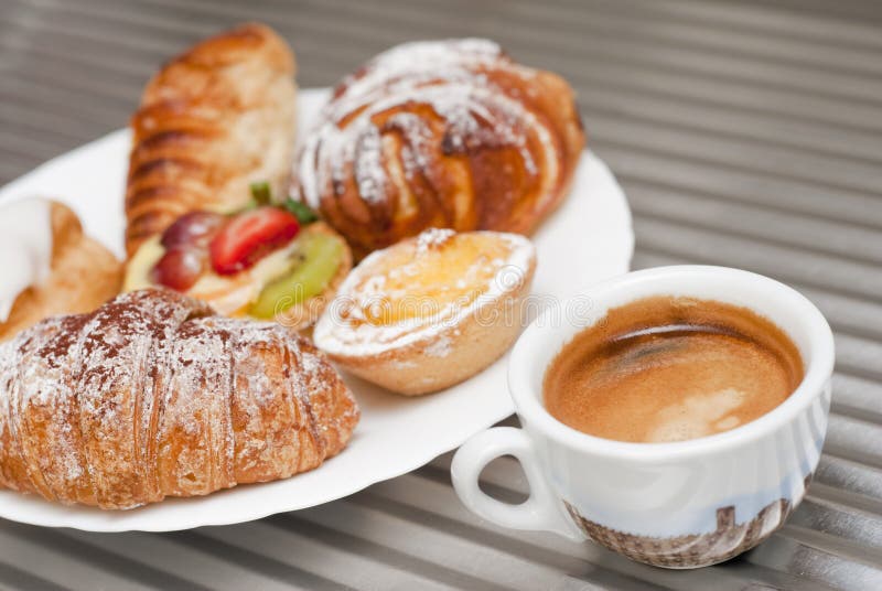 Cup of coffee with a plate of pastries. Cup of coffee with a plate of pastries