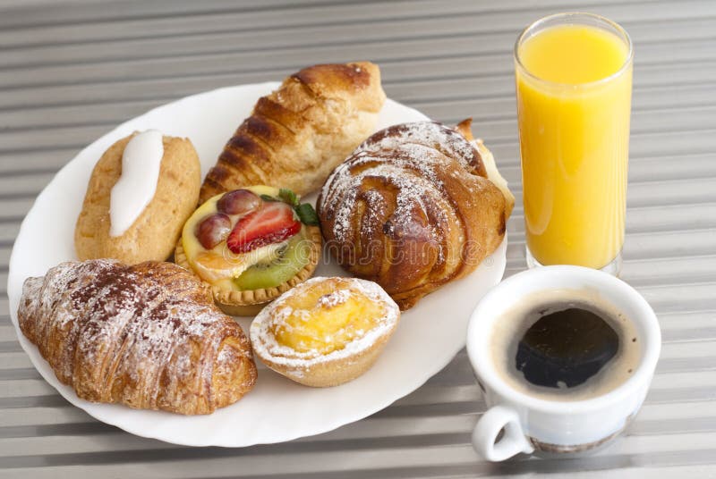 Breakfast time with coffee, pastry and orange juice. Breakfast time with coffee, pastry and orange juice