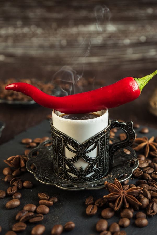 Traditional turkish coffee in vintage cup, anise, roasted beans with hot spicy chili pepper on brown background 4. Traditional turkish coffee in vintage cup, anise, roasted beans with hot spicy chili pepper on brown background 4