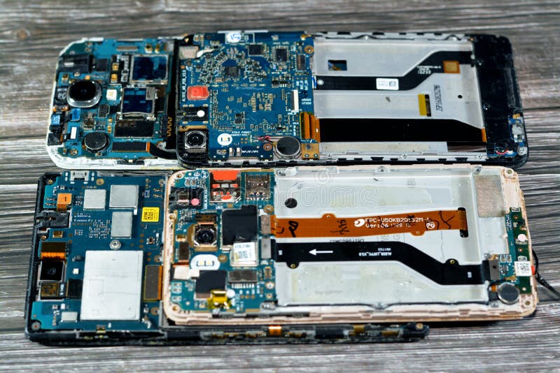 Cairo, Egypt, November 9 2022: Smartphone cellular mobile devices from inside with motherboard electronic chip, camera and SIM royalty free stock photos