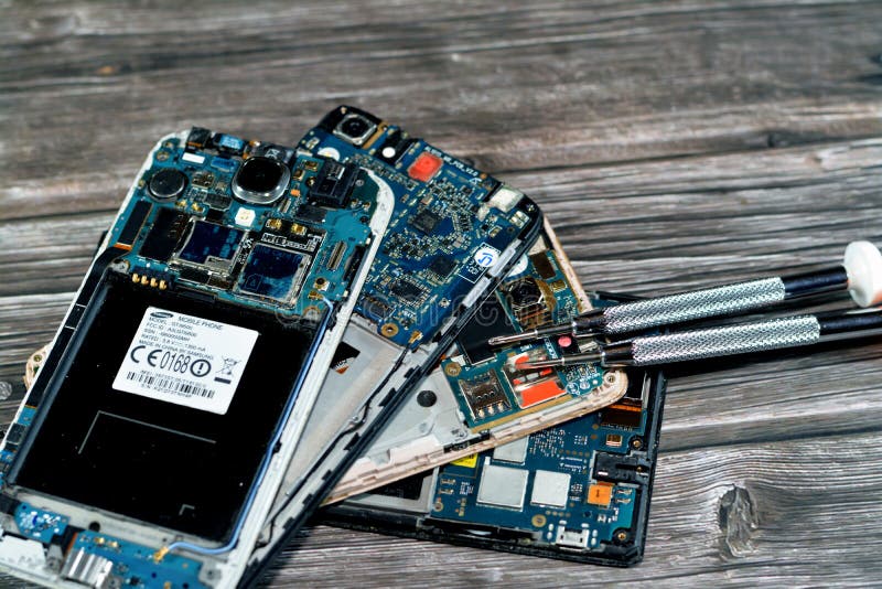 Cairo, Egypt, November 9 2022: Smartphone cellular mobile devices from inside with motherboard electronic chip, camera and SIM royalty free stock photo