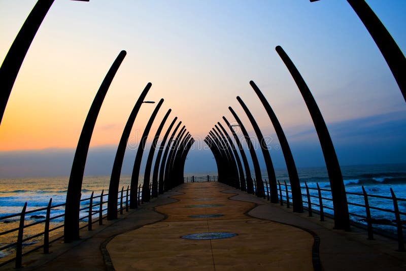 Beautiful warm colorful sunrise over seaside pier, picture taken in Umhlanga beach, Durban, south africa. Beautiful warm colorful sunrise over seaside pier, picture taken in Umhlanga beach, Durban, south africa