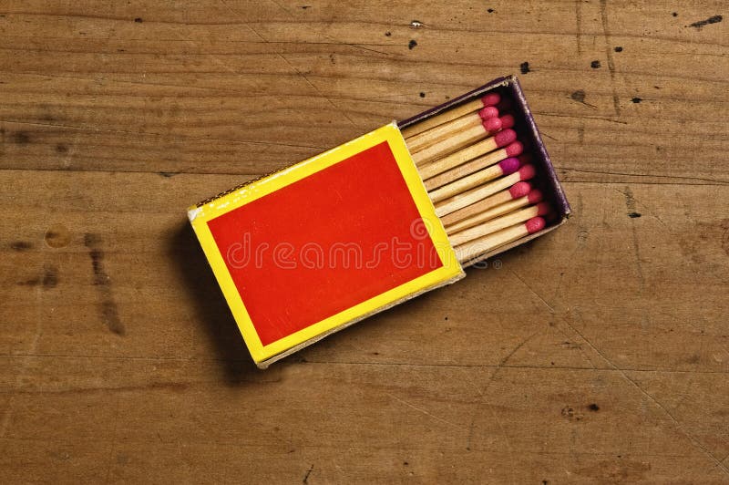 Overhead view of open matchbox and matches on old wooden table. Overhead view of open matchbox and matches on old wooden table.
