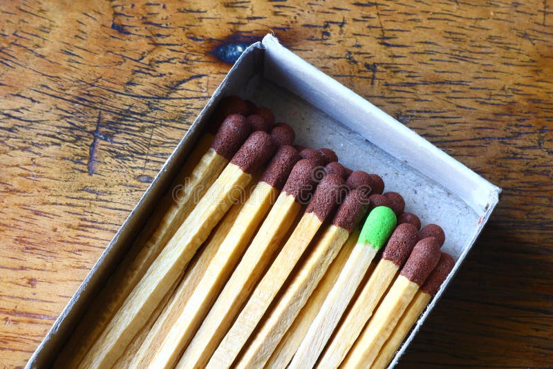 Matchbox of brown matches with a green one. This image can be used as metaphore of a good idea. In a matchbox there are many matches (ideas) but one can be very different, the good one. Matchbox of brown matches with a green one. This image can be used as metaphore of a good idea. In a matchbox there are many matches (ideas) but one can be very different, the good one.