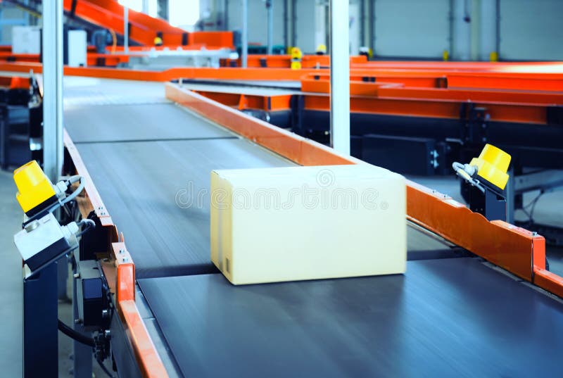 Empty conveyor sorting belt at distribution warehouse. Distribution hub for sorting packages and parcels delivered by air transportation. Empty conveyor sorting belt at distribution warehouse. Distribution hub for sorting packages and parcels delivered by air transportation.