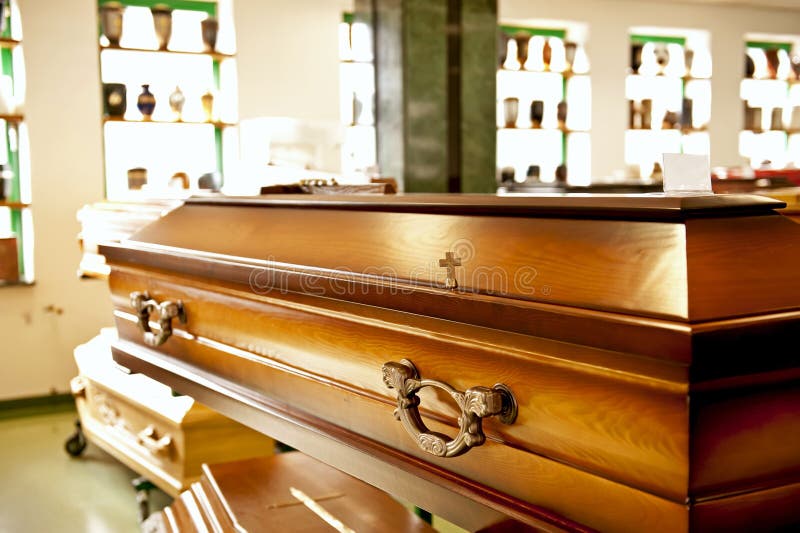 Close up of the wooden casket displayed in a casket store. Close up of the wooden casket displayed in a casket store.