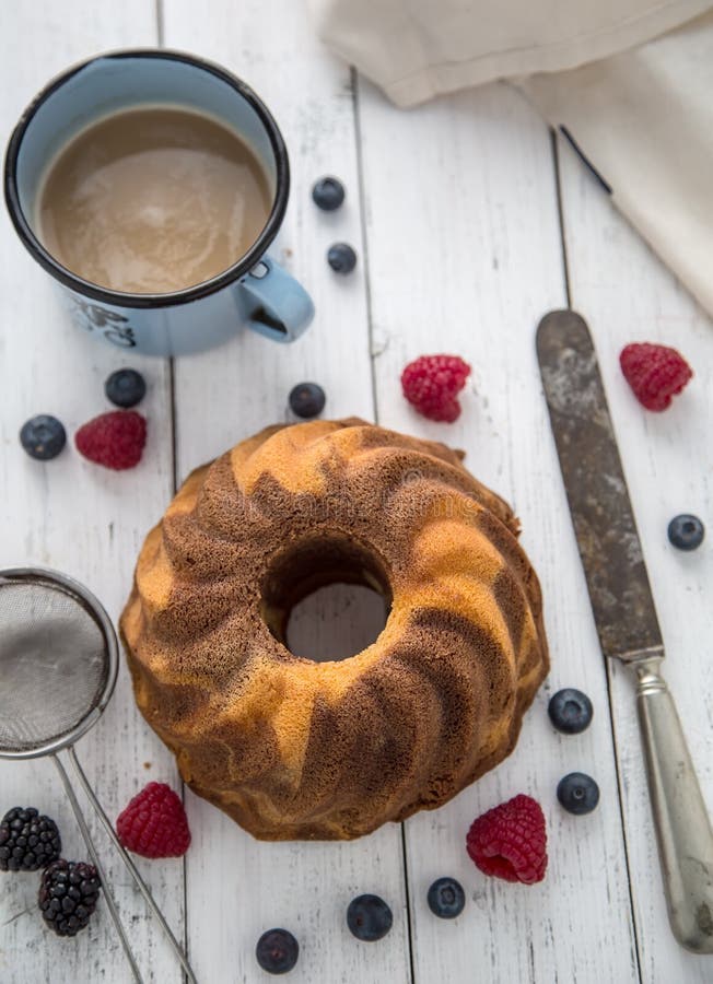 Cake. Marble cake cup of coffee powder sugar kitchen vintage utensil and fresh fruit berries