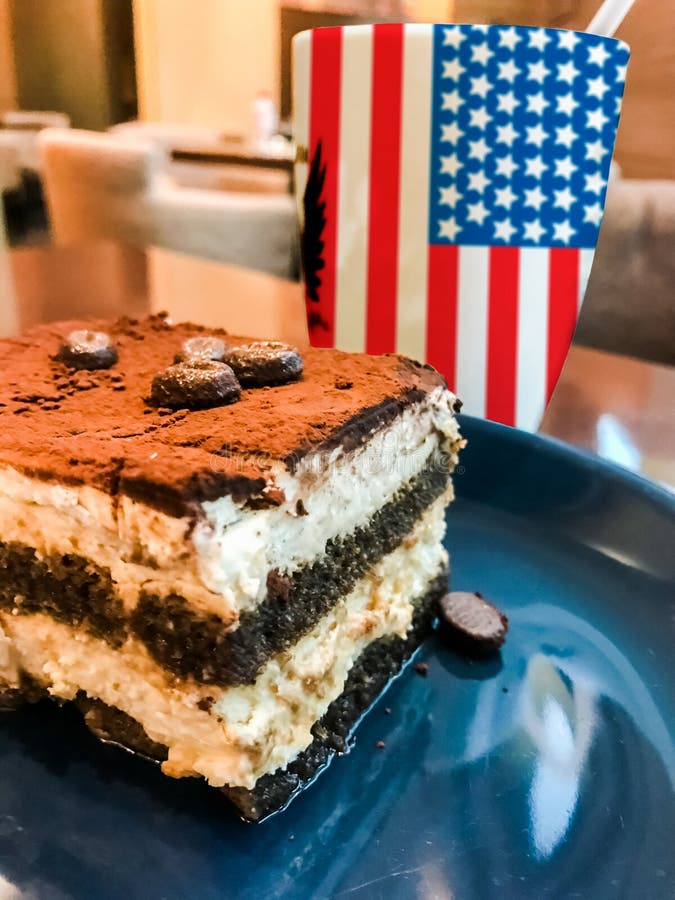 Cup of coffee with USA flag print and tasty cream cake Tiramisu royalty free stock photos Cup of coffee with USA flag print and tasty cream cake Tiramisu royalty free stock photos