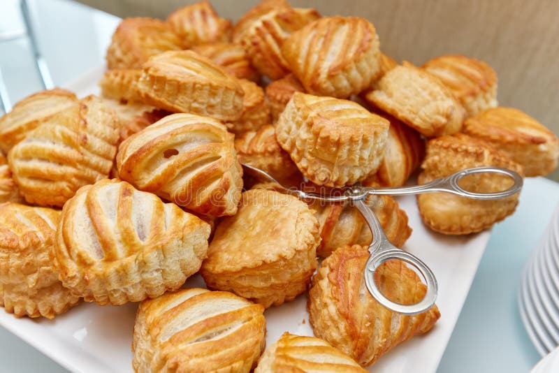 Cakes on a Plate and Tongs for Cakes Stock Image Image of buffet