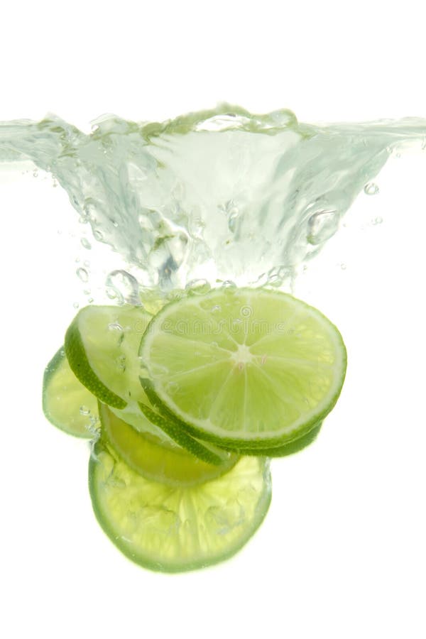 Lime thrown into the water with splash, on white background. Lime thrown into the water with splash, on white background.