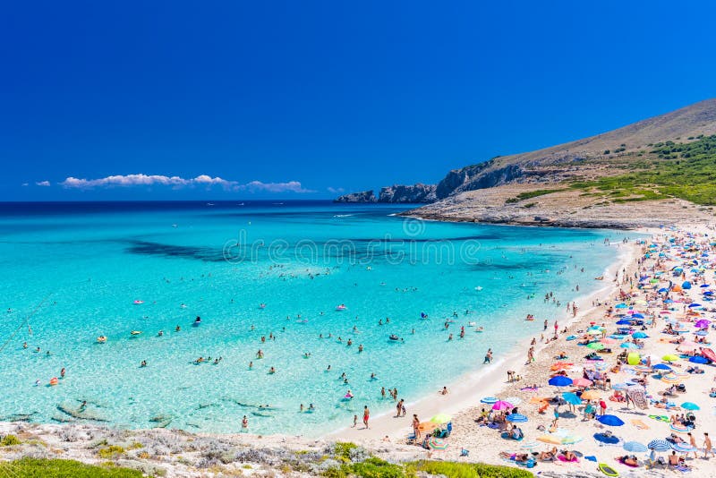 CALA MESQUIDA, MALLORCA, SPAIN - 19 July 2020: People enjoying beautiful sandy beach of on Mallorca, Mediterranean Sea, Spain. CALA MESQUIDA, MALLORCA, SPAIN royalty free stock image CALA MESQUIDA, MALLORCA, SPAIN - 19 July 2020: People enjoying beautiful sandy beach of on Mallorca, Mediterranean Sea, Spain. CALA MESQUIDA, MALLORCA, SPAIN royalty free stock image