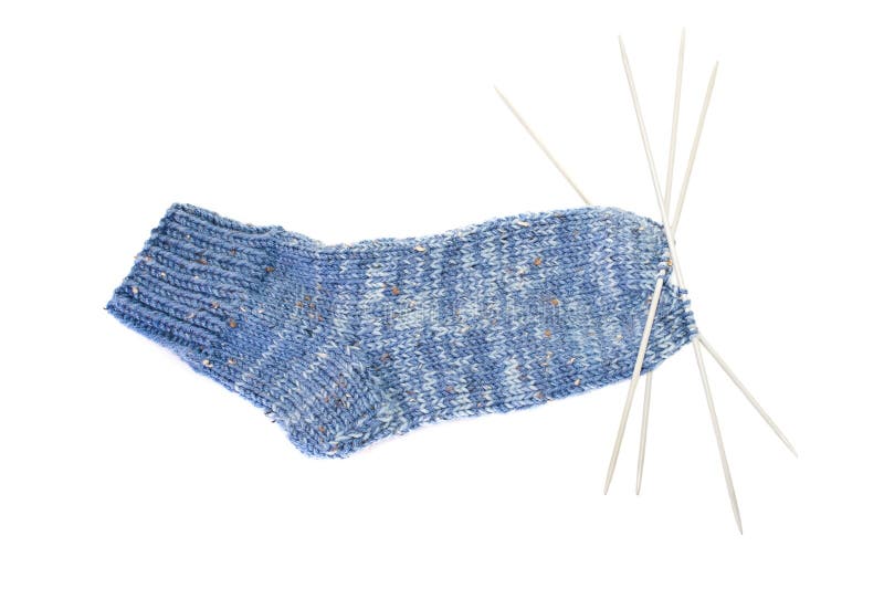 Wool socks with knitting needles on a white background. Wool socks with knitting needles on a white background