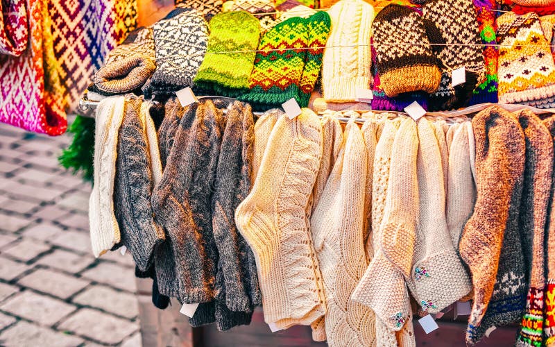 Knitted socks souvenirs in stalls at Christmas market in Riga of Latvia winter. Europe. Street Xmas and holiday fair in European city or town. Advent Decoration with Crafts Items on Bazaar. Knitted socks souvenirs in stalls at Christmas market in Riga of Latvia winter. Europe. Street Xmas and holiday fair in European city or town. Advent Decoration with Crafts Items on Bazaar