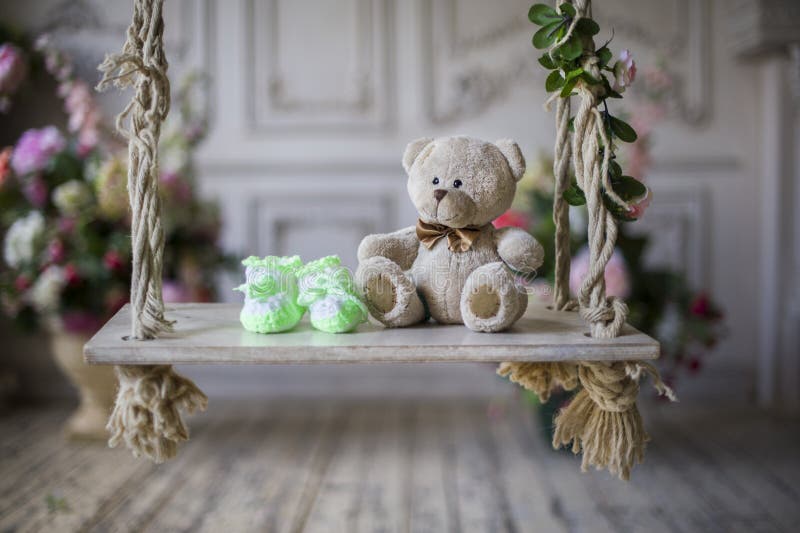 Knitted socks and bear waiting for the baby. Knitted socks and bear waiting for the baby