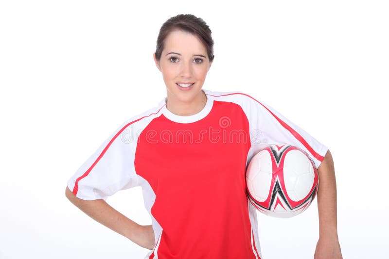 Calcio della tenuta della ragazza immagini stock libere da diritti Calcio della tenuta della ragazza immagini stock libere da diritti