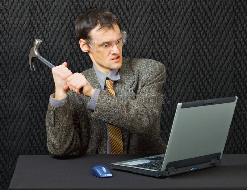 Comical person intends to break the computer with a hammer. Comical person intends to break the computer with a hammer