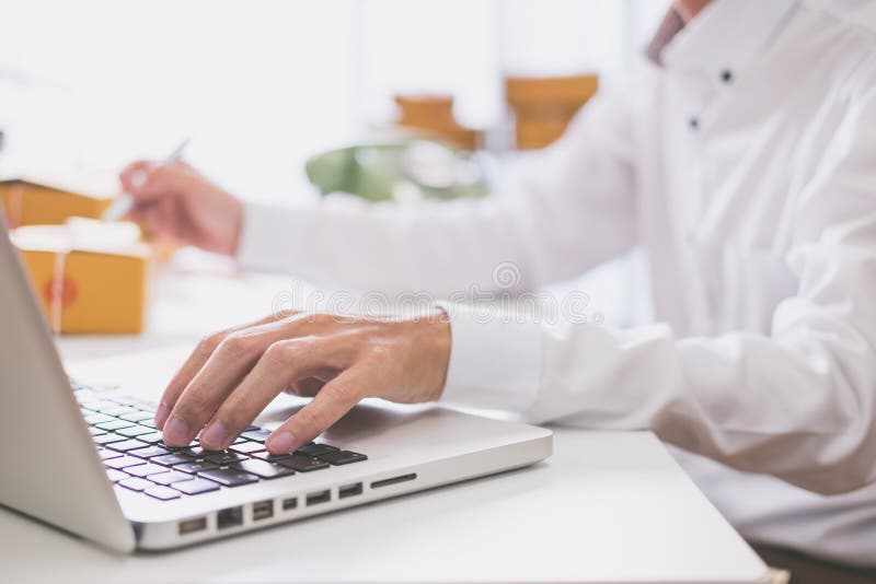 Calculating the cost of postage of a small package stock photo Calculating the cost of postage of a small package stock photo