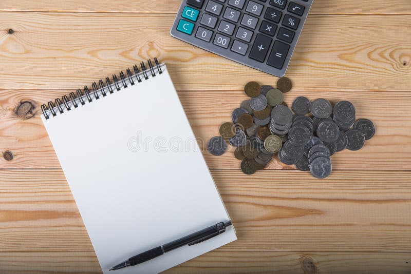 Calculator, coins, notepad and pen royalty free stock photos