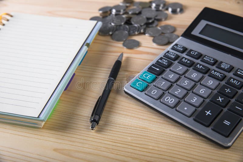 Calculator, coins, notepad and pen royalty free stock photography