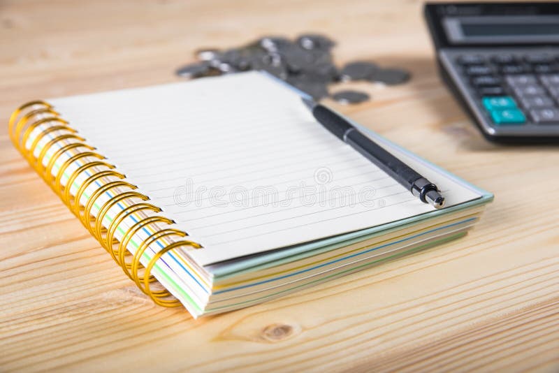 Calculator, coins, notepad and pen royalty free stock images