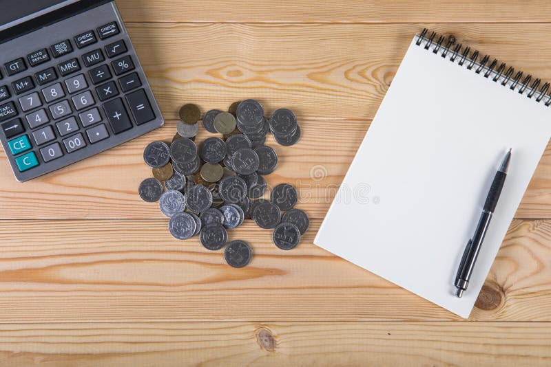 Calculator, coins, notepad and pen royalty free stock image