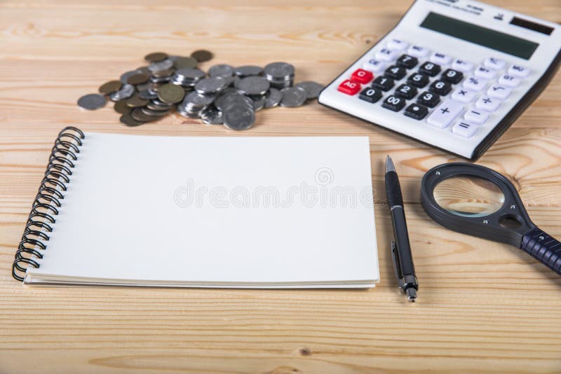 Calculator, coins, notepad and pen stock image