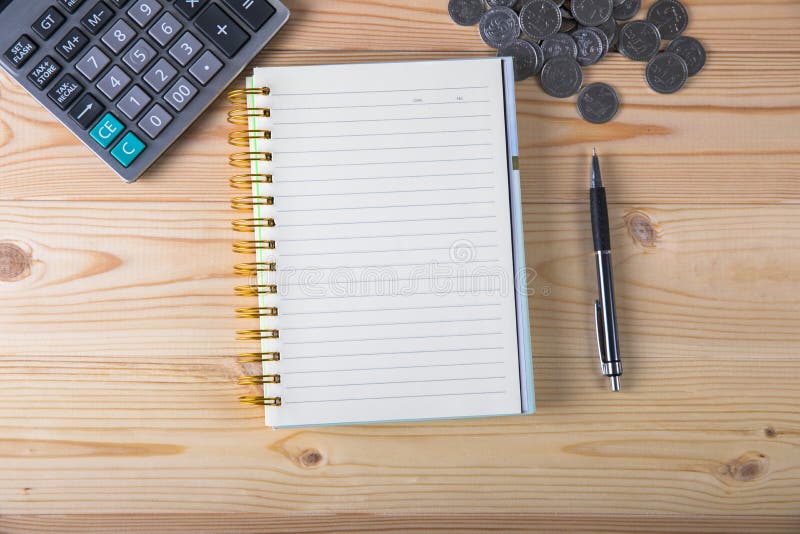 Calculator, coins, notepad and pen stock photo