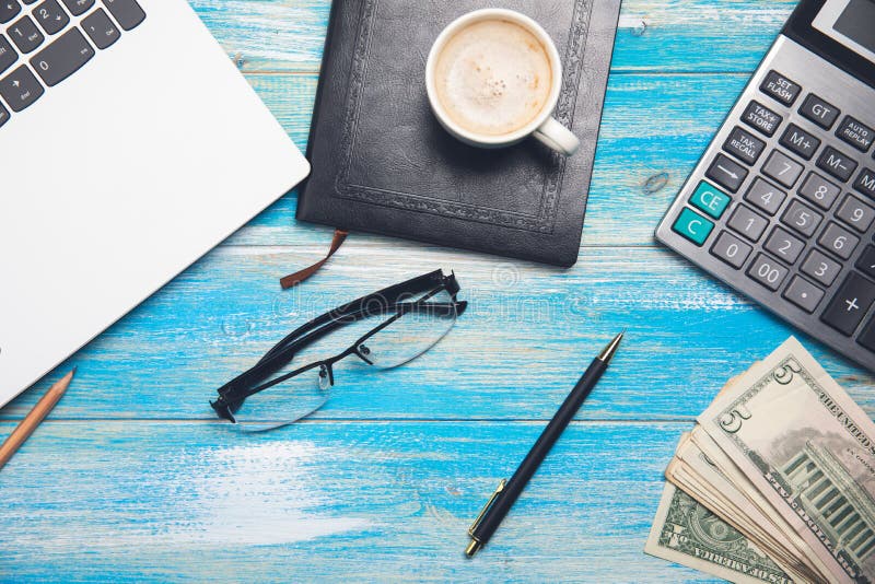 Calculator, money, notebook, notepad, glasses and coffee stock image