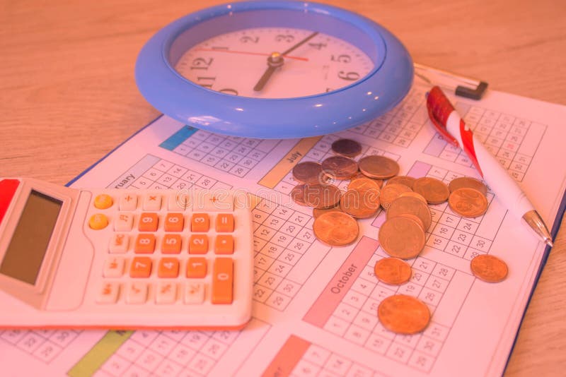 Calculator with Pen and Money on Calendar. Coin Stack with a Clock Background Stock Image