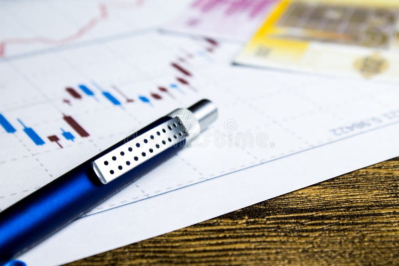 Calculator,pencil and money on graffica the Dow Jones. Analysis, bill.