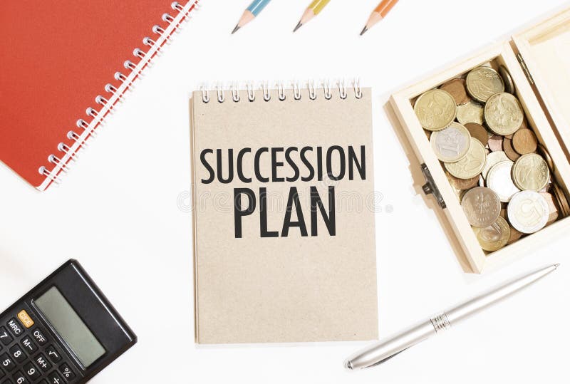 Calculator,red notepad, three colour pencils, silver pen and brown notebook with text SUCCESSION PLAN royalty free stock photography