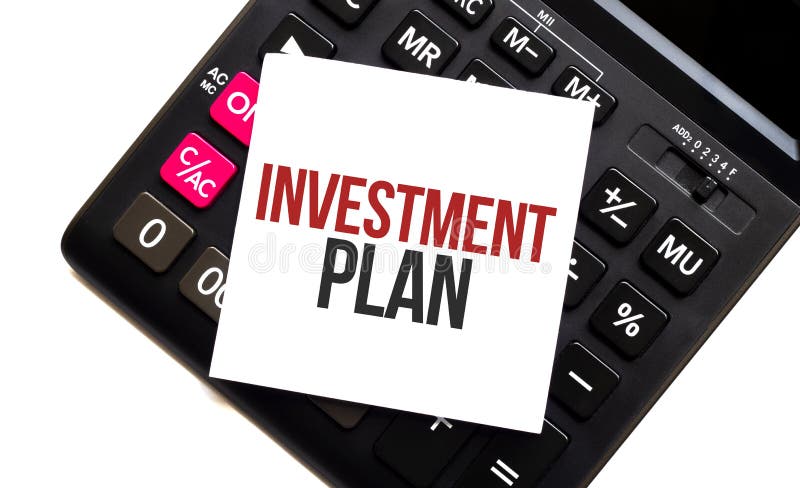 Calculator with text INVESTMENT PLAN with white paper royalty free stock images