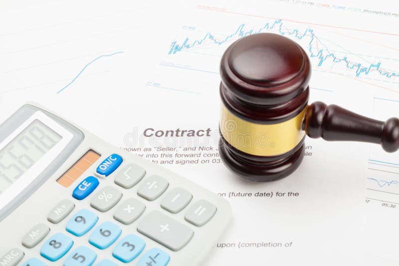 Calculator and wooden judge`s gavel over financial document - close up studio shot royalty free stock photography Calculator and wooden judge`s gavel over financial document - close up studio shot royalty free stock photography