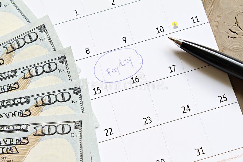 Calendar with blue marker circle in word payday and American dollars cash money for remind stock photo Calendar with blue marker circle in word payday and American dollars cash money for remind stock photo