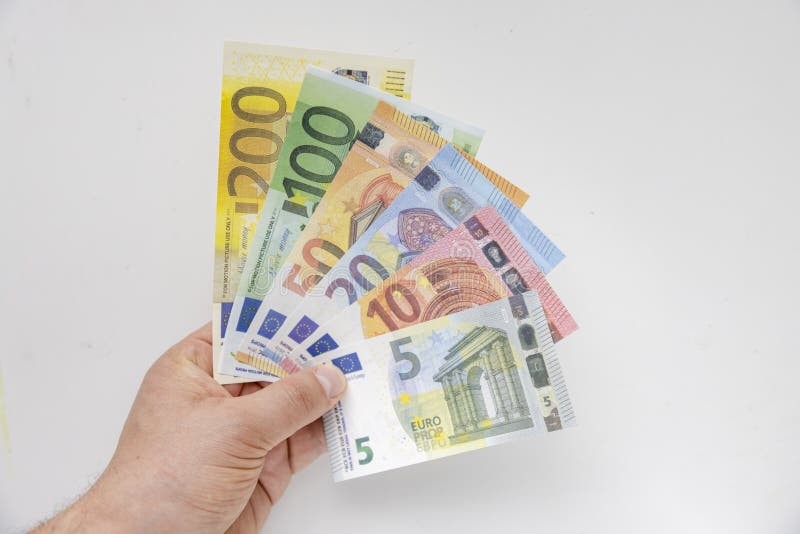A Person holding Euros banknotes on a clear background