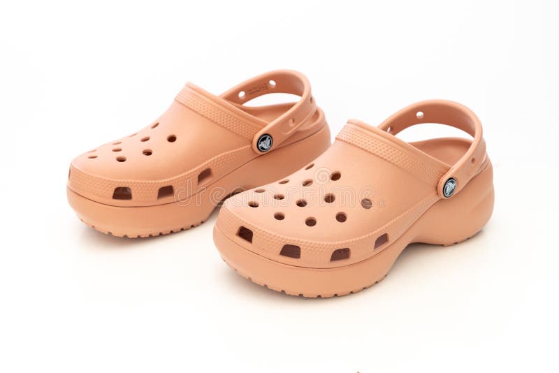 Front view of a couple of Pink Crocs Sandals on a white table