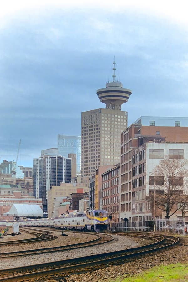 The Vancouver Harbour Centre Building and a Passenger Train Traversing