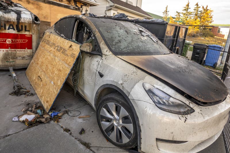 An Electric Tesla Car with Fire Damage in from a Front House Garage