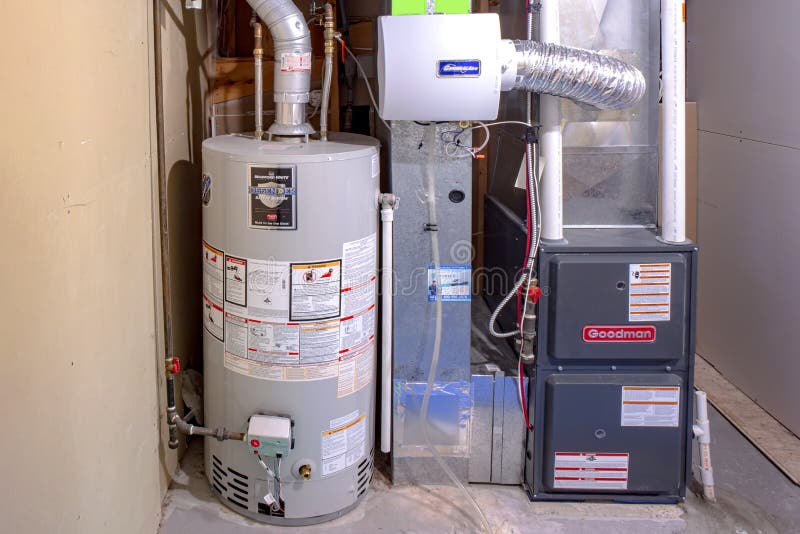 A home Goodman high efficiency furnace with Bradford White Residential gas water heater & royalty free stock photos