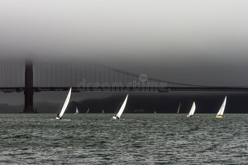 The California the city of San Francisco Golden Gate Bridge sailing on foggy afternoon