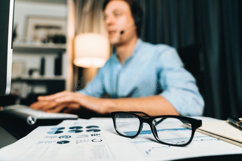 Call center consulting with customer on headphones on business graph. Pecuniary. stock photography