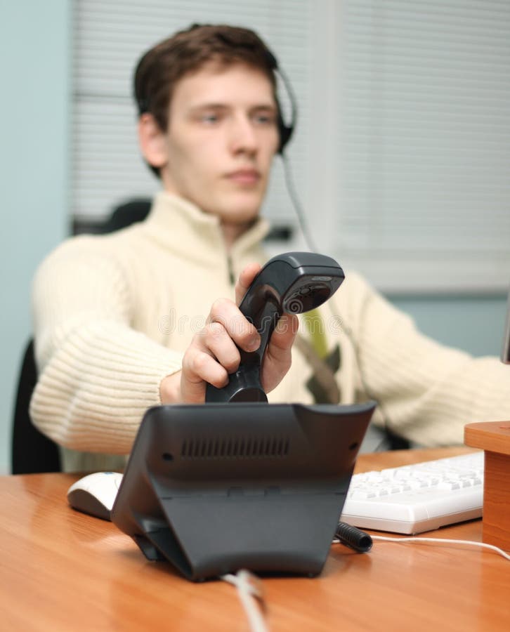 Call center operator answering a call, focus on the receiver