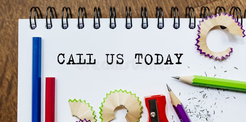 CALL US TODAY Text Written on a Paper with Pencils in Office Stock