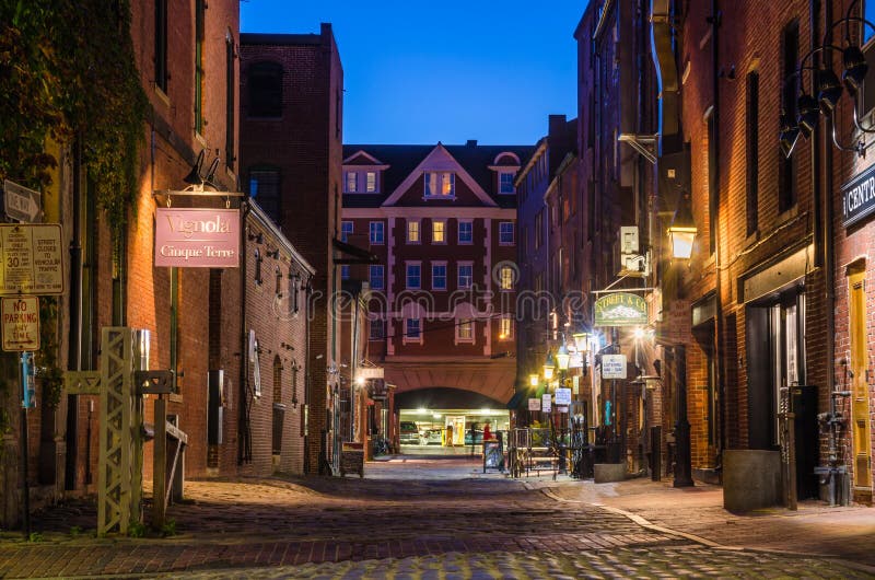 Cobbled street Lined with shops and pubs in the Old Port District of Portland, Maine, at night. Cobbled street Lined with shops and pubs in the Old Port District of Portland, Maine, at night
