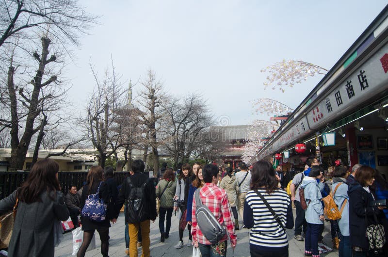 TOKYO, JAPAN - FEBRUARY 23,2015: Nakamise shopping street in Asakusa, Tokyo. The busy arcade connects Senso-ji Temple to it's outer gate Kaminarimon, which can just be seen in the distance. TOKYO, JAPAN - FEBRUARY 23,2015: Nakamise shopping street in Asakusa, Tokyo. The busy arcade connects Senso-ji Temple to it's outer gate Kaminarimon, which can just be seen in the distance