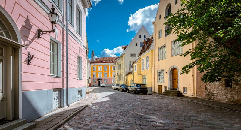 Colorful buildings along the cobblestone street in the old town of Tallinn. Travel image of Tallinn on a beautiful sunny summer day. No people. Colorful buildings along the cobblestone street in the old town of Tallinn. Travel image of Tallinn on a beautiful sunny summer day. No people.