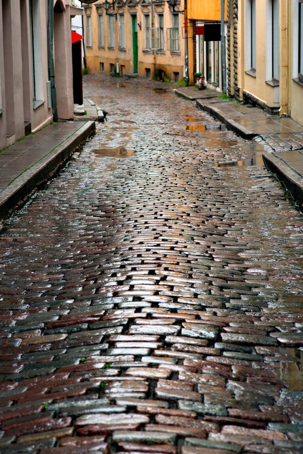 Wet cobblestones after rain on narrow street in the old town of Tallinn, Estonia. Wet cobblestones after rain on narrow street in the old town of Tallinn, Estonia